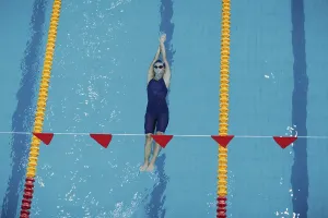 Woman In Swimsuit Prints: Young woman swimmer swims in swimming pool