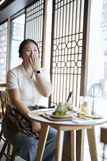 Female Portrait Photography Prints: In a chic cafe at a window table
