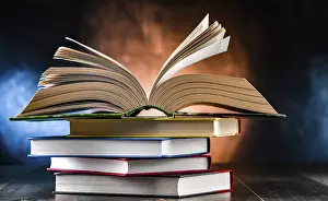 Book Stack Prints: A composition with an open book lying on a stack of other books