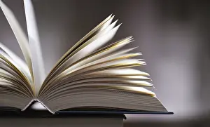 Literature Study Space Prints: A composition with an open book lying on a stack of other books