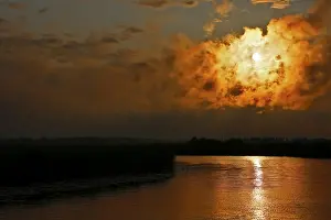 Dramatic Cloud Formations Europe Prints: Dramatic cloud formation at sunset reflected in a calm river
