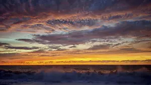 Dramatic Cloud Formations Prints: Dramatic sunset with powerful cloud formations and breaking waves in the foreground