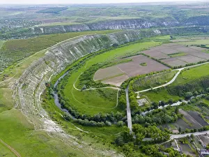 Prints of Extensive landscape with river, fields and hills in lush green from a bird's eye view, aerial view of the Răut river loop, Raut, Old Orhei, Orheiul Vechi, archaeological site Moldova Prints: Aerial View of Raut River Loop, Orheiul Vechi Print