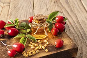Alternative Medicine Prints: Rosehip Seed Oil Print on Wooden Board