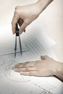 Construction Project Planning Prints: Hands of engineer working on a construction plan