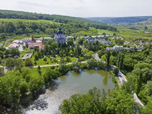 Prints of Landscape view with calm lake, hills and a cathedral on the horizon surrounded by green nature, aerial view, Cathedral of the Nativity of the Virgin Mary, Curchi monastery, Orhei district Moldova Prints: Landscape Print: Calm Lake, Hills and Cathedral in Moldova