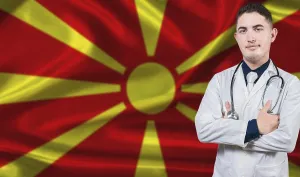 Prints of Portrait of medical professional on North Macedonia flag background. Macedonian national health system North Macedonia Prints: North Macedonia Flag Print with Medical Professional