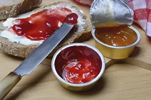 Basic Food Still Life Images Prints: Slice of bread with jam and jam in portion pack