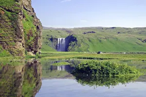 Icelands Natural Wonders Prints: Vertically falling waterfall reflected in the water