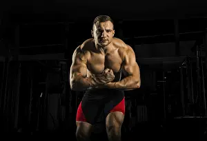 Frontal View Photography Prints: The weightlifter is posing in front of the camera