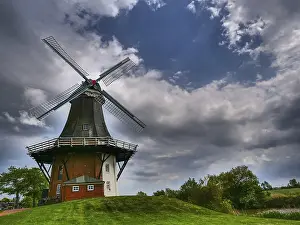 Atmospheric European Landscape Prints: A windmill in front of a dramatic sky