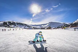 Prints of Woman, falling down when learning how to ride on a snowboard. Winter ski holidays in El Tarter, Grandvalira, Andorra, Pyrenees Mountains Andorra Prints: Woman Learning to Snowboard, El Tarter Print