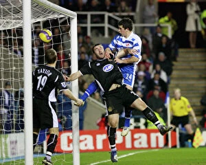 Images Dated 31st January 2007: Shane Long rises above Wigans David Unsworth to score his 51st minute goal